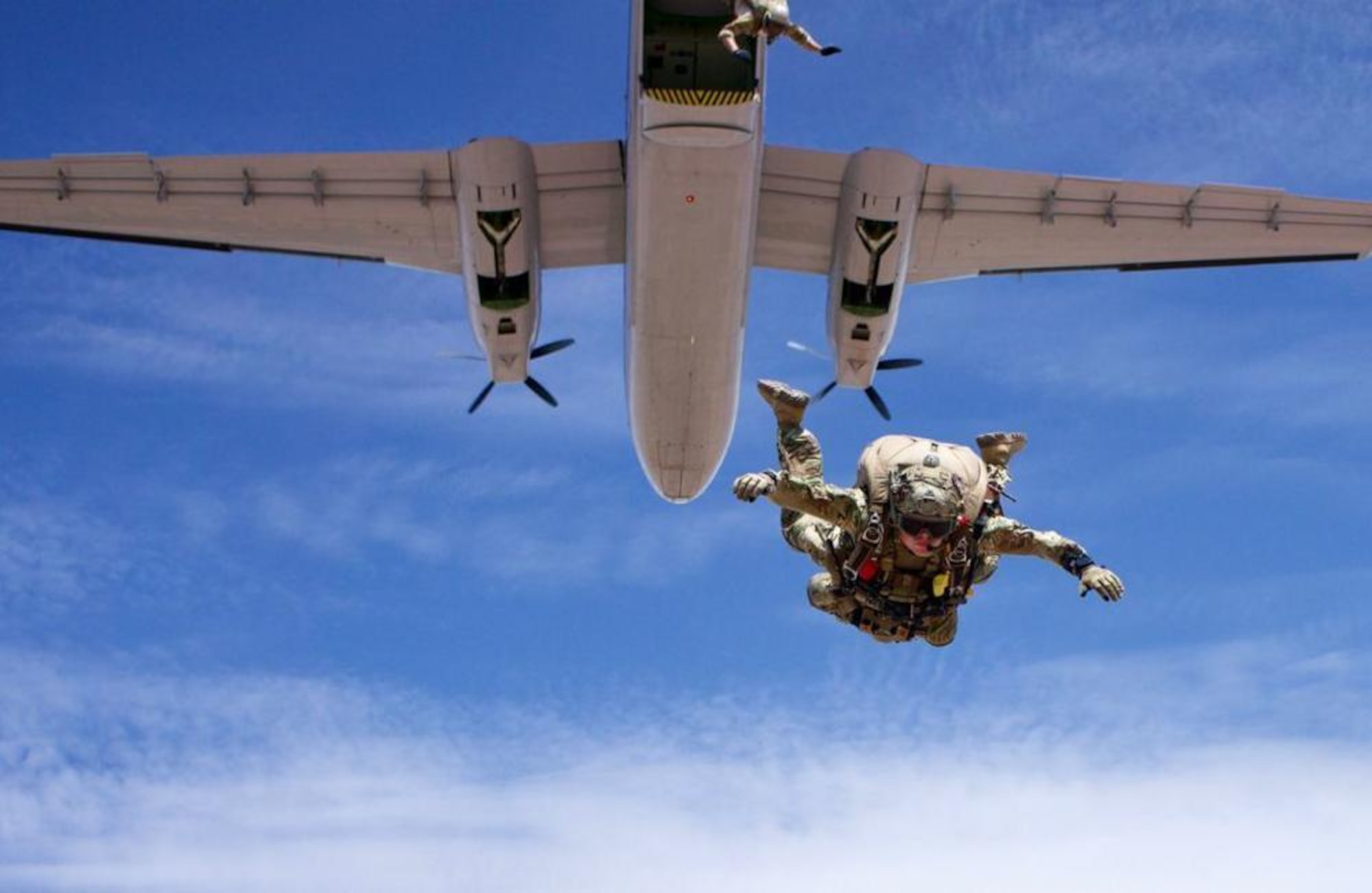 U.S. Air Force Capt. Hopkins, 351st Special Warfare Training Squadron, Instructor Flight commander and Chief Combat Rescue Officer (CRO) instructor, conducts a military free fall equipment jump from a DHC-4 Caribou aircraft in Coolidge, Arizona, July 17, 2021.