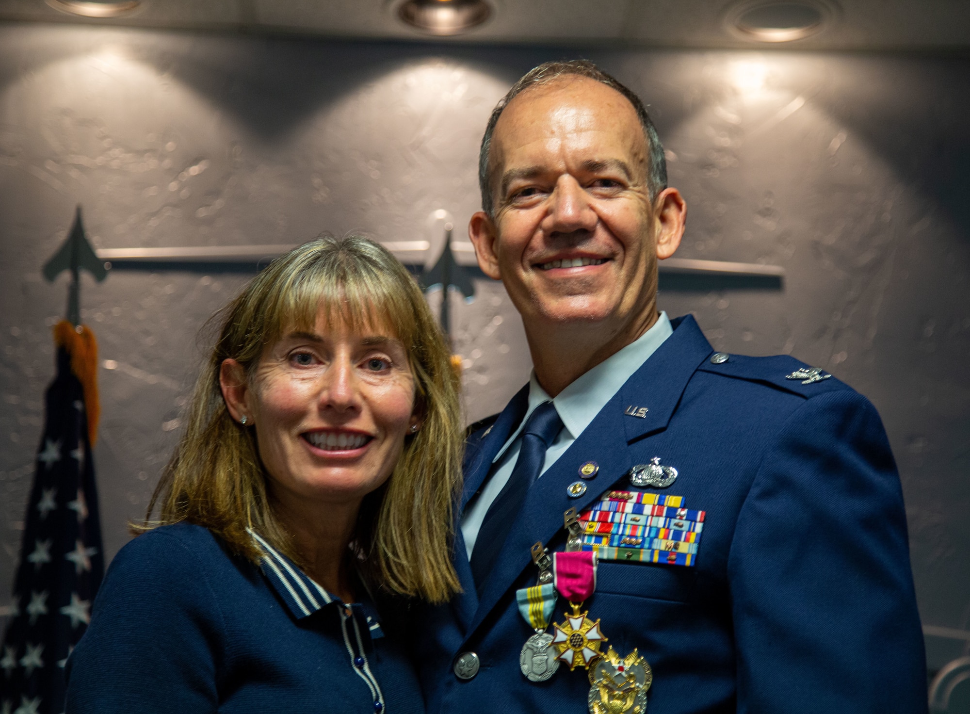 Airman and woman pose for photo.