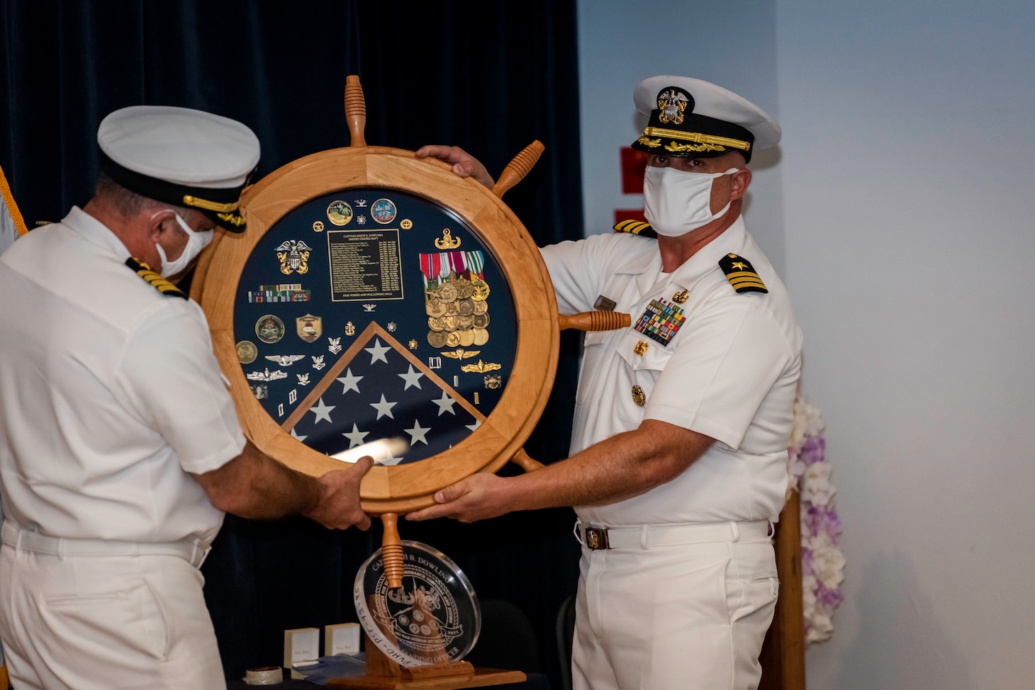 Capt. Keith Dowling, right, receives a shadow box as part of his retirement ceremony held during a change of command for the Center for Explosive Ordnance Disposal and Diving  (CEODD), Sept. 22.  Dowling retired after nearly 38 years of service in the U.S. Navy.