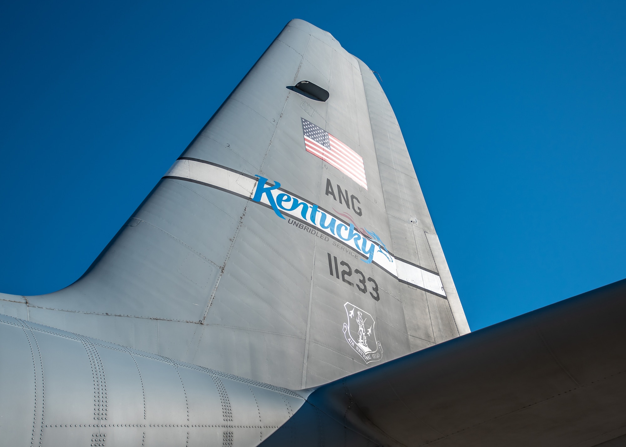 The last of eight C-130 H-model aircraft departs the Kentucky Air National Guard Base in Louisville, Ky., Sept. 24, 2021, as the 123rd Airlift Wing prepares to convert to the C-130J Super Hercules. The unit is slated to begin receiving the most modern variant of the venerable transport plane Nov. 6. In the meantime, the departing H-models — which the Kentucky Air Guard has flown since 1992 — are being transferred to the Delaware Air National Guard. Tail number 11233 has logged 9,967 hours of flight time all over the world, supporting every kind of mission from humanitarian airlift to combat resupply operations. (U.S. Air National Guard photo by Lt. Col. Dale Greer)