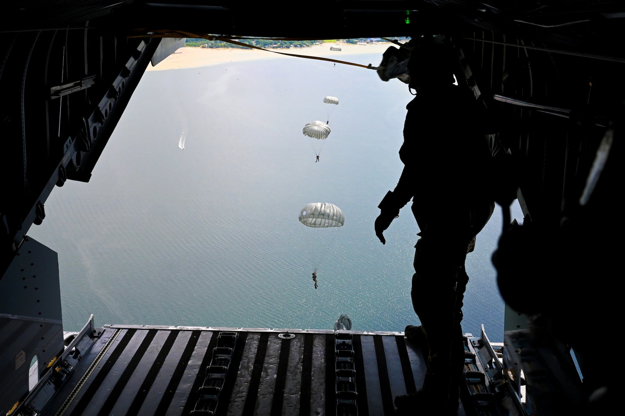 Special Tactics operators from the 24th Special Operations Wing perform a static line jump into the ocean in order to search for and rescue simulated civilian casualties swept to sea by a tsunami Sept. 6, 2021,