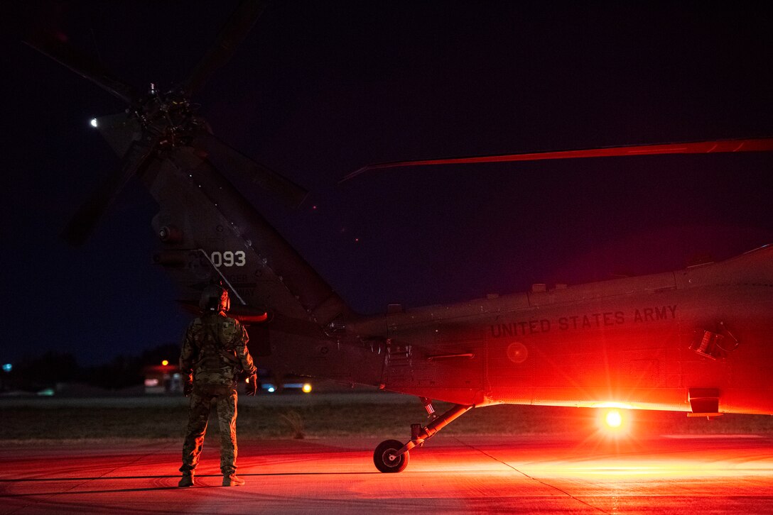 U.S. Army soldier assigned to Task Force Black Cat inspects a UH-60 Black Hawk