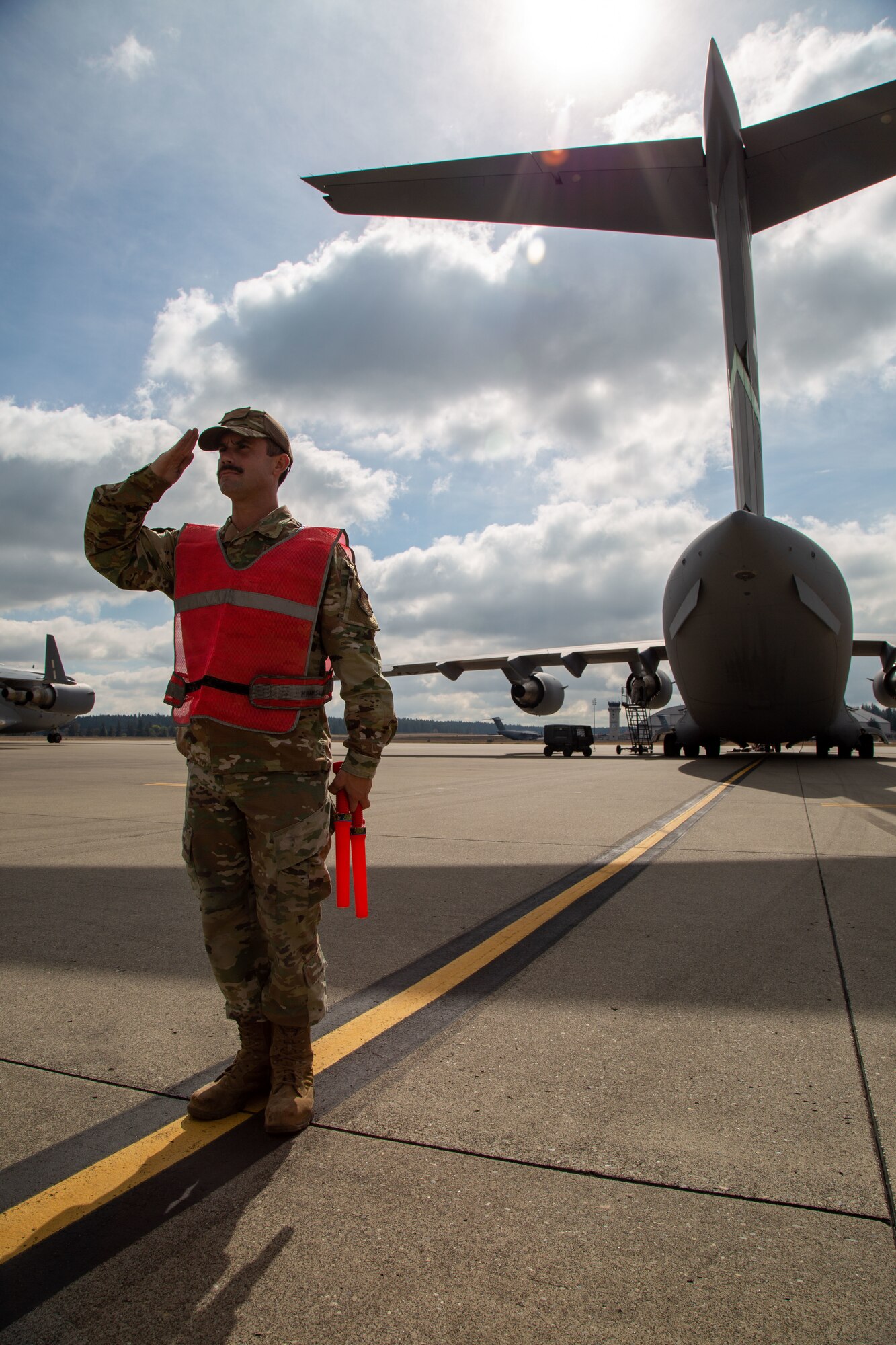 Airman salutes on flight line