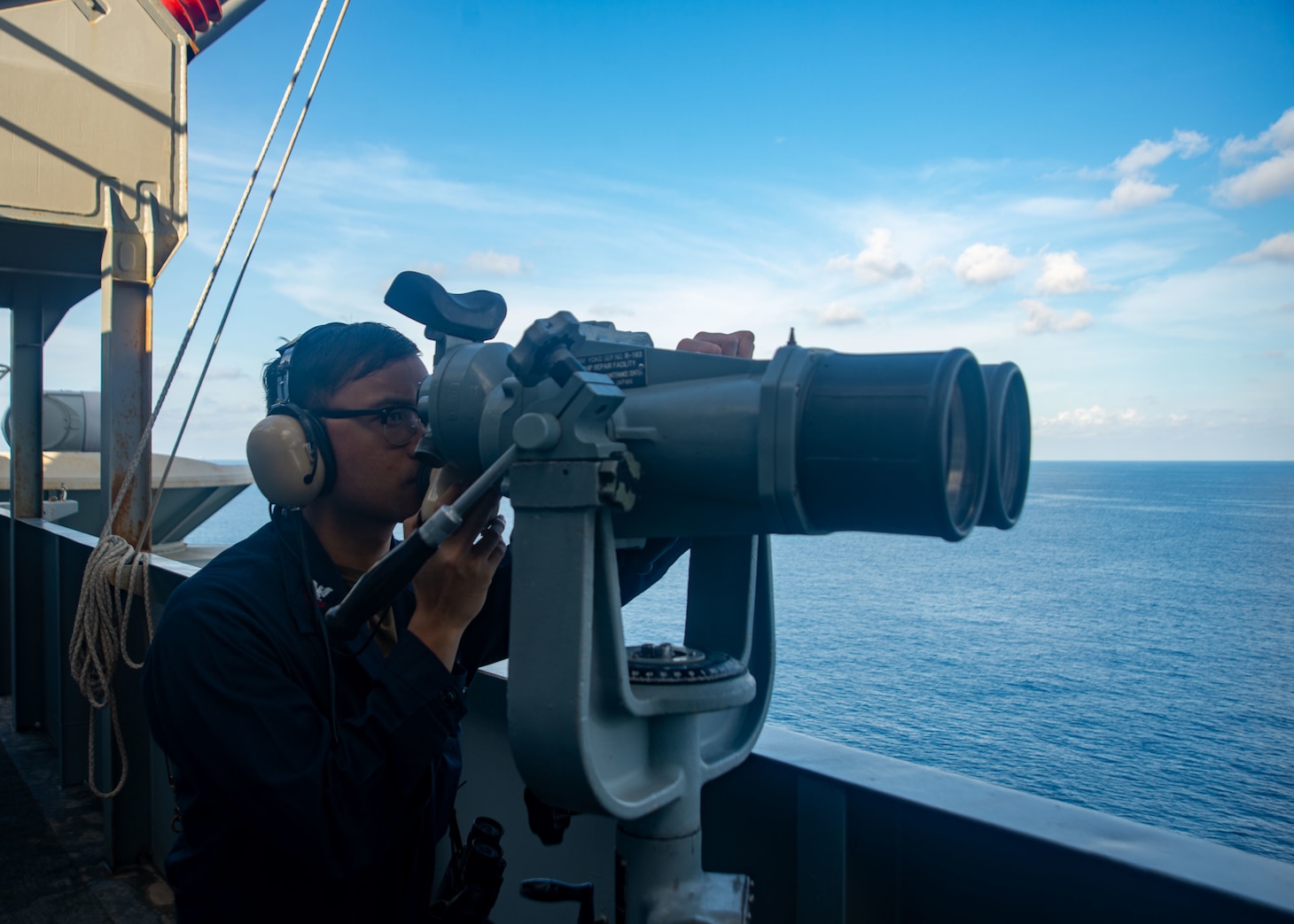 SOUTH CHINA SEA (Sept. 24, 2021) Operations Specialist 2nd Class Darren Osias, from Salinas, Calif., stands watch aboard the U.S. Navy’s only forward-deployed aircraft carrier USS Ronald Reagan (CVN 76). Ronald Reagan, the flagship of Carrier Strike Group 5, provides a combat-ready force that protects and defends the United States, and supports alliances, partnerships and collective maritime interests in the Indo-Pacific region.