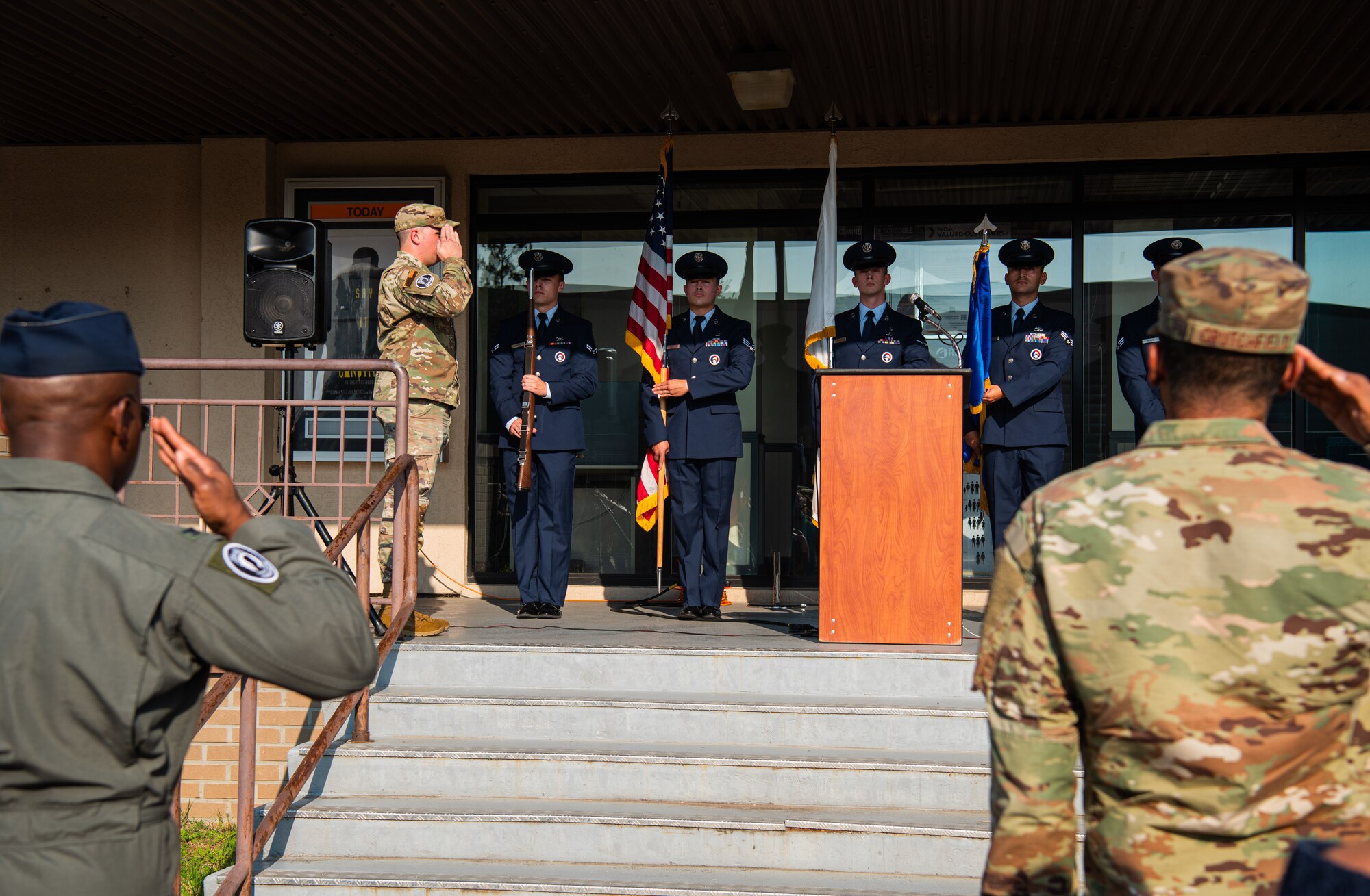 Service members salute the Base Honor Guard during a Prisoner of War and Missing in Action ceremony Sept. 24, 2021, at Osan Air Base, Republic of Korea.