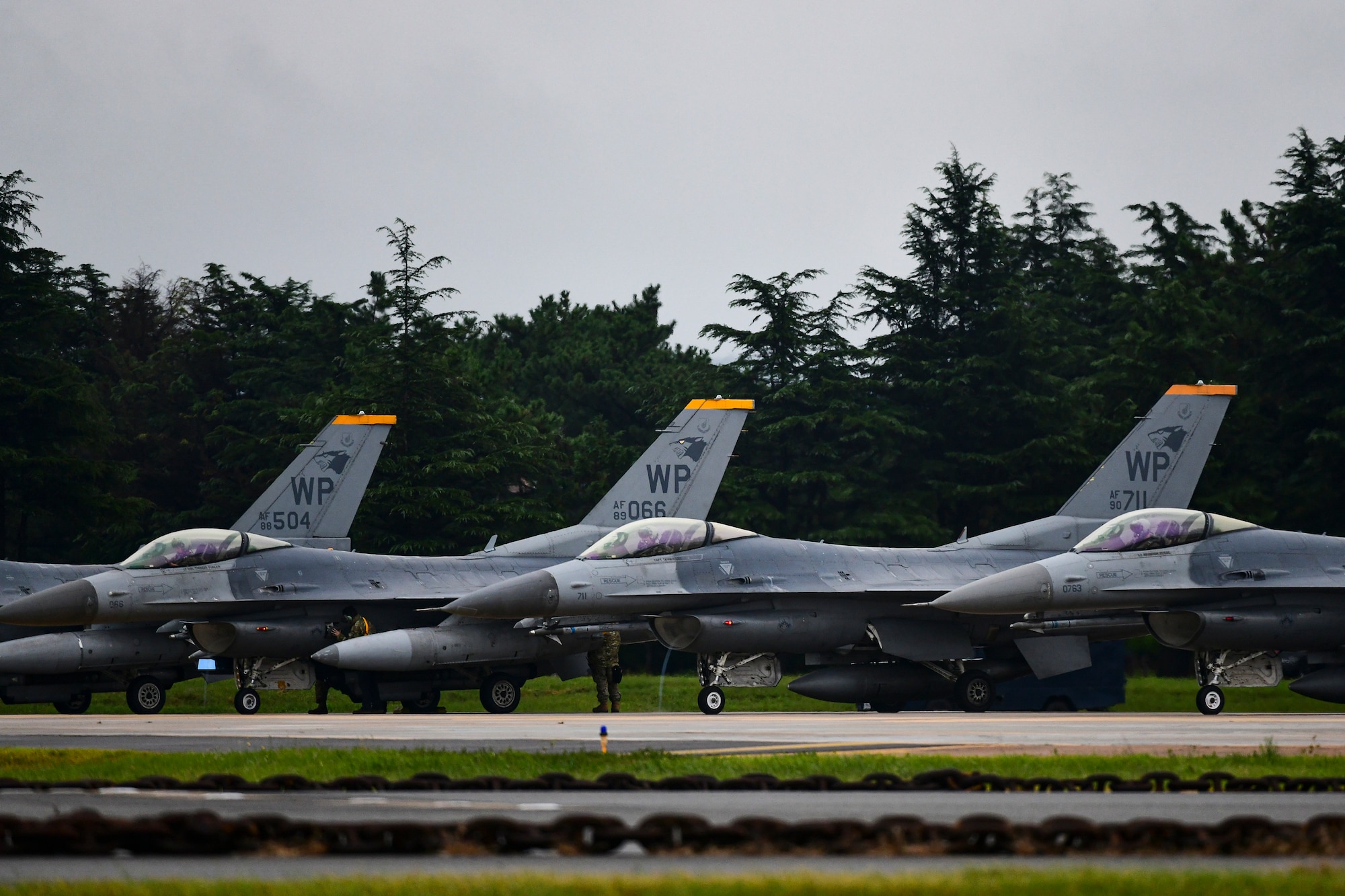 Three jets wait to take off.