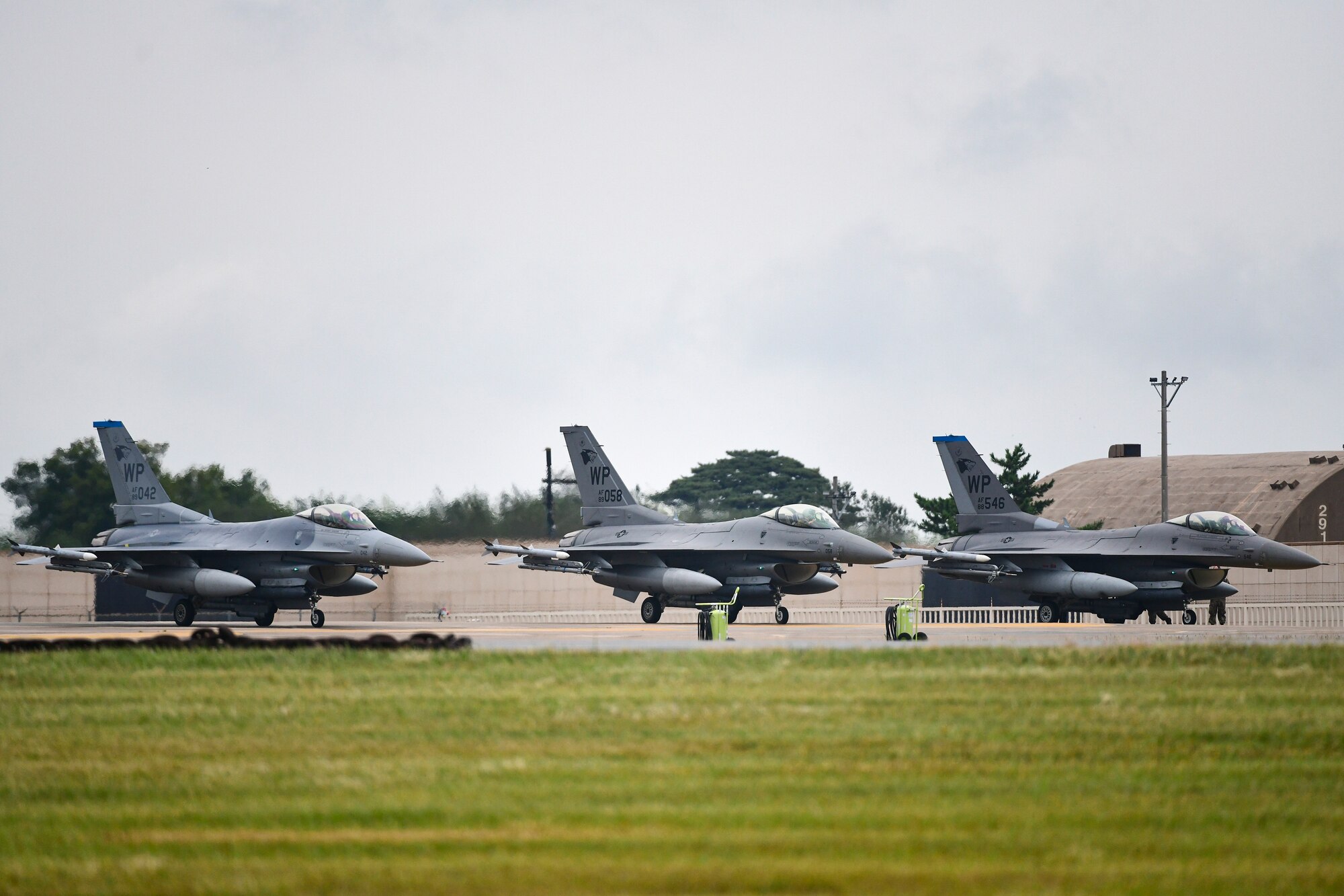 Three jets wait to take off.