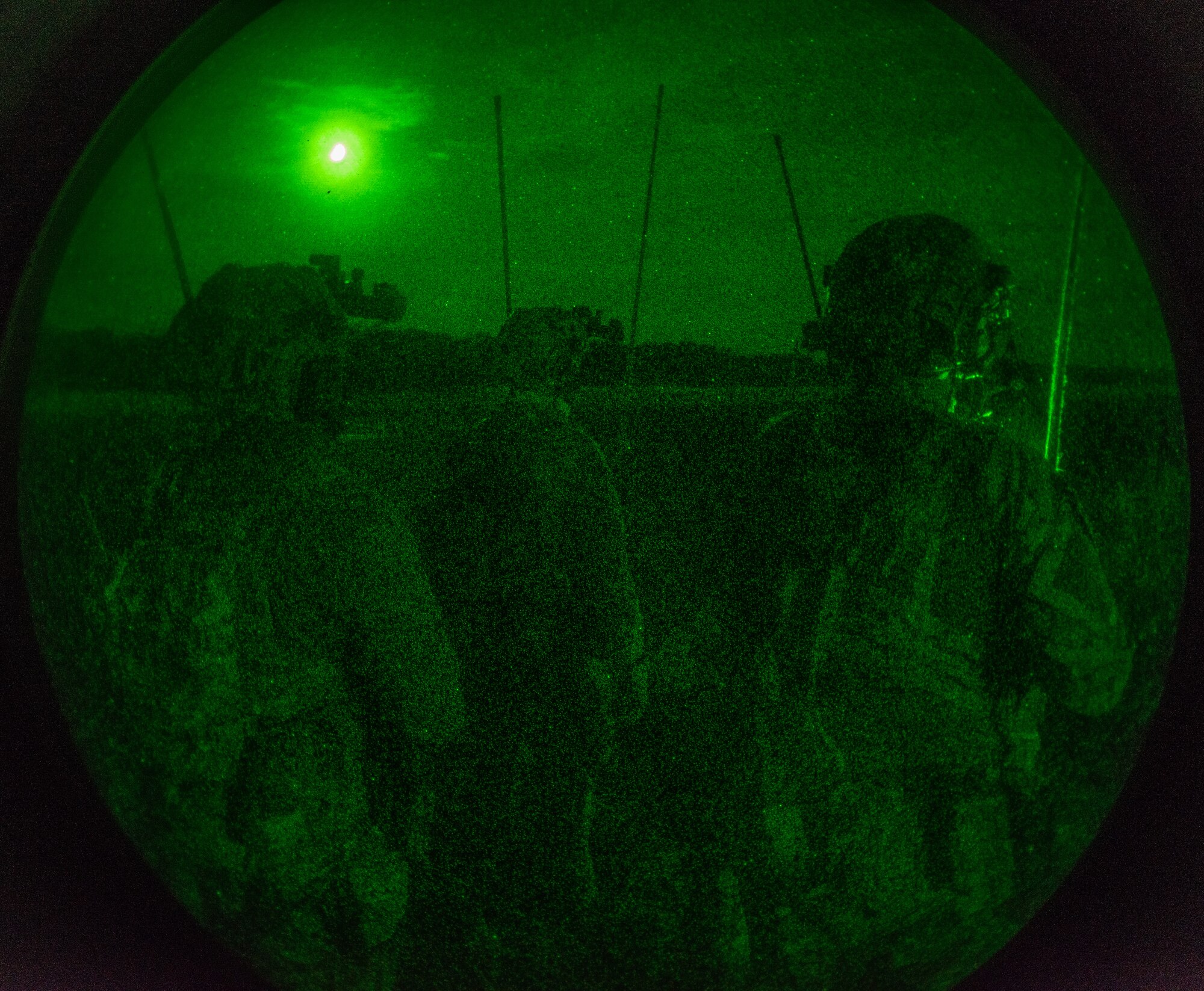 Airmen perform exercises on runway at night.