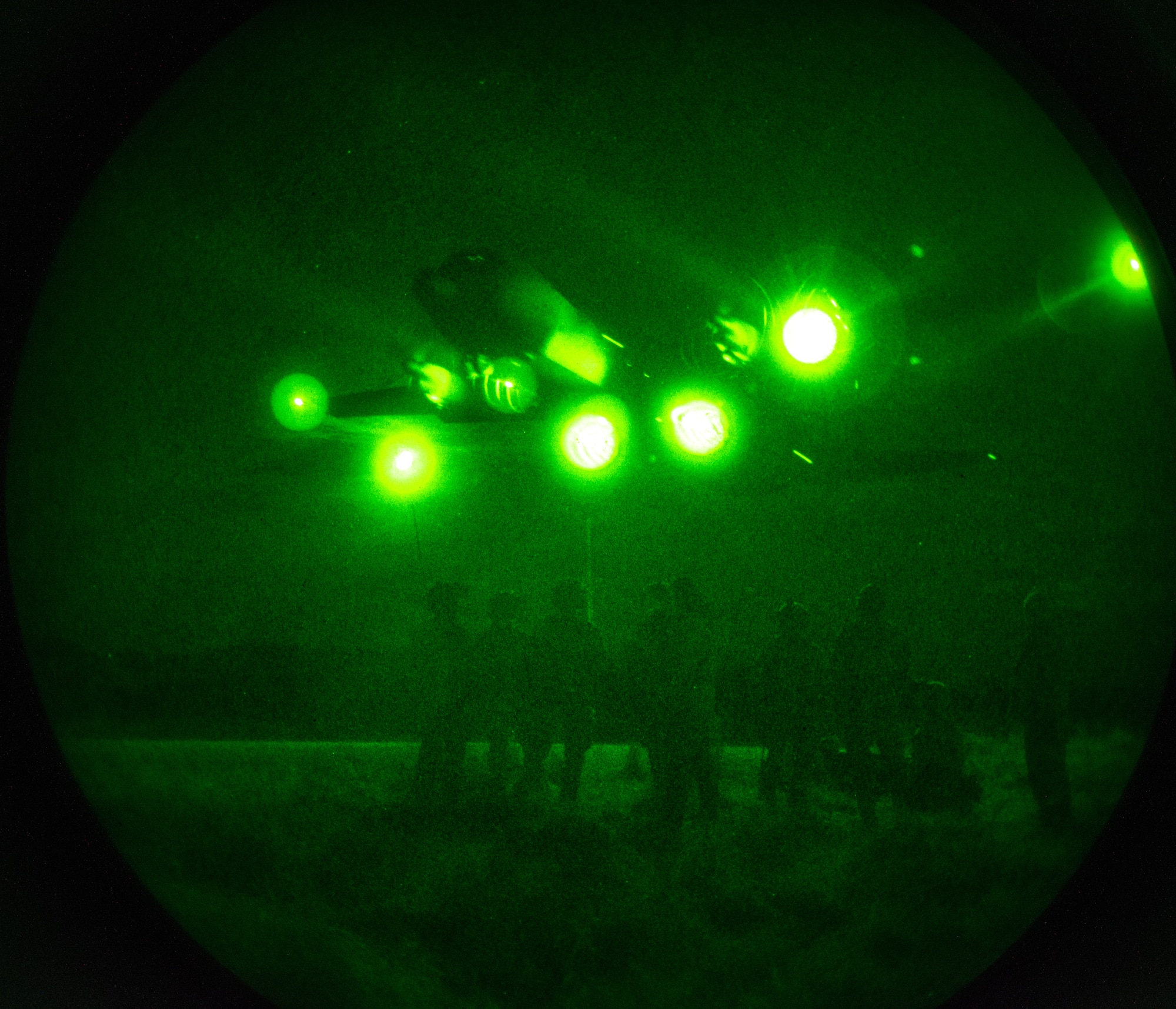 Airmen maneuver runway at night.