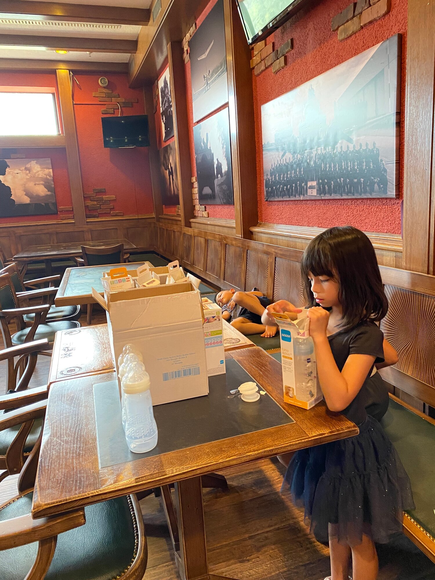 Girl sanitizes baby bottles.