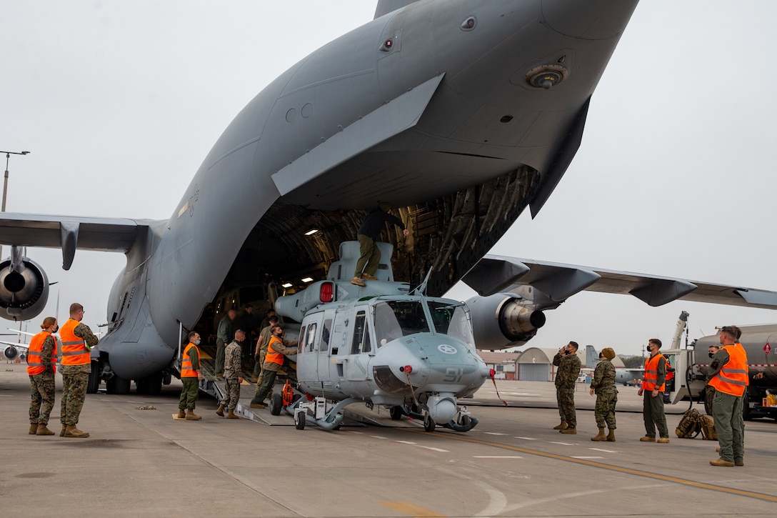U.S. Marines with Marine Light Attack Helicopter Squadron (HMLA) 269 unload a UH-1Y Venom helicopter from a C-17 Globemaster III plane during UNITAS LXII in Lima, Peru, Sept. 23, 2021. UNITAS is the world's longest-running annual multinational maritime exercise that focuses on enhancing interoperability among multiple nations and joint forces during Pacific, amphibious, and amazon operations in order to build on existing regional partnerships and create new enduring relationships that promote peace, stability and prosperity in the U.S. Southern Command's area of responsibility. HMLA-269 is a subordinate unit of 2nd Marine Aircraft Wing, the aviation combat element of II Marine Expeditionary Force. (U.S. Marine Corps photo by Lance Cpl. Elias E. Pimentel III)