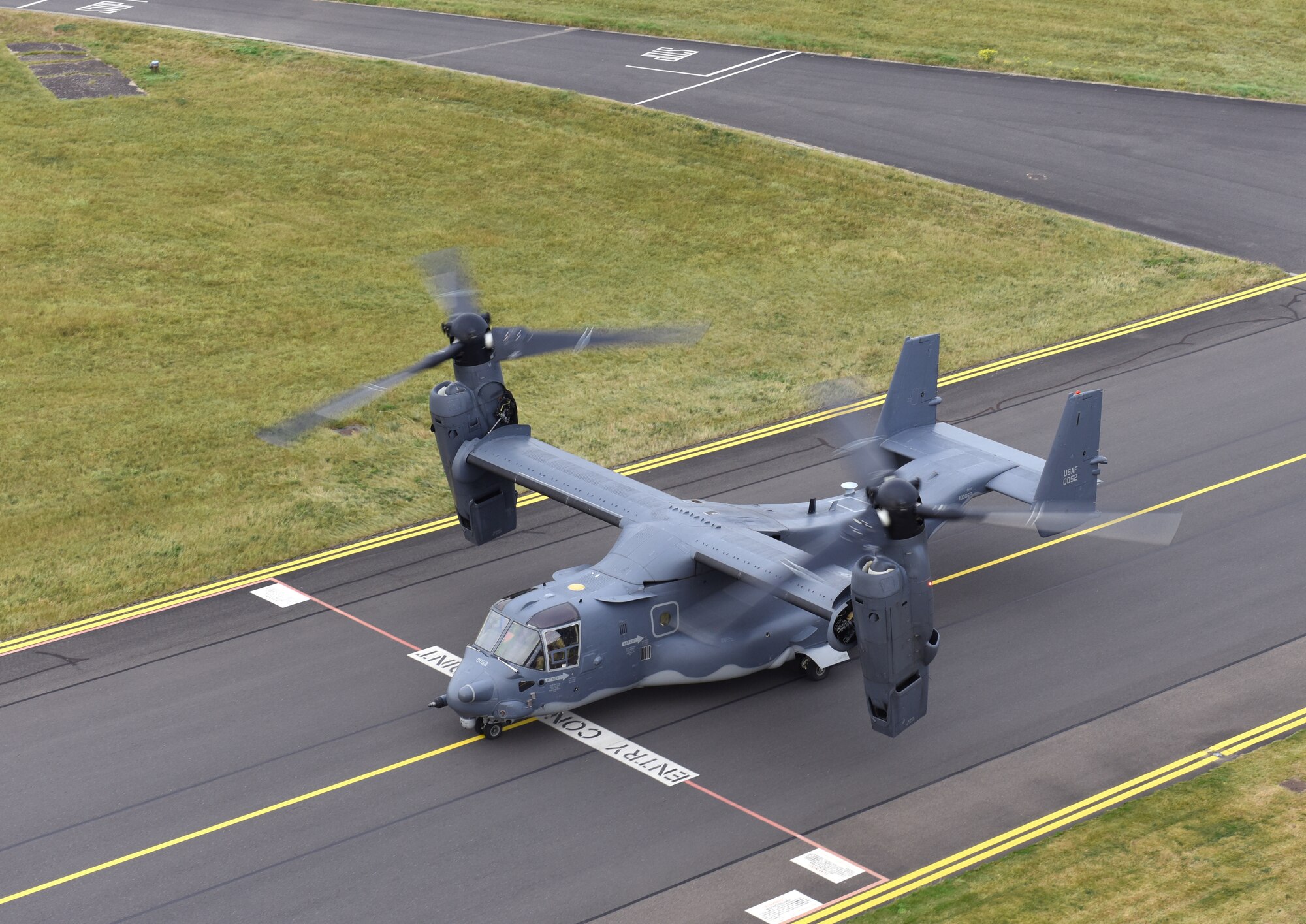 A U.S. Air Force CV-22B Osprey aircraft assigned to the 352nd Special Operations Wing taxis in front of the air traffic control tower on its way to lead an “elephant walk” at Royal Air Force Mildenhall, England, Sept. 13, 2021. An elephant walk is a term used by the U.S. Air Force when multiple aircraft taxi together before takeoff. (U.S. Air Force photo by Karen Abeyasekere)
