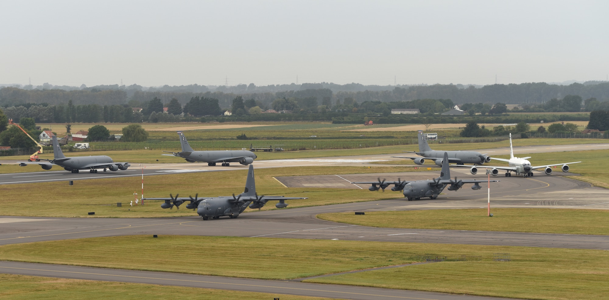 U.S. Air Force MC-130J Commando II, RC-135 Rivet Joint and KC-135 Stratotanker aircraft taxi along the flightline as they prepare to take off after an “elephant walk” at Royal Air Force Mildenhall, England, Sept. 13, 2021. An elephant walk is a term used by the U.S. Air Force when multiple aircraft taxi together before takeoff. (U.S. Air Force photo by Karen Abeyasekere)