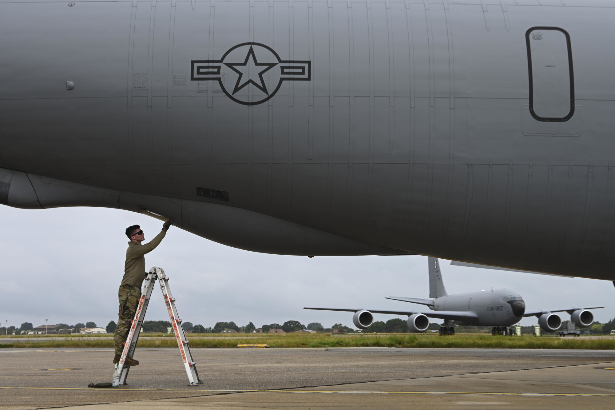U.S. Air Force Staff Sgt. Lane Lucas, 100th Aircraft Maintenance Squadron crew chief, performs post-flight maintenance on the boom pod window of a KC-135 Stratotanker aircraft at Royal Air Force Mildenhall, England, Aug. 31, 2021. The 100th AMXS supports the 100th Air Refueling Wing's mission of providing air refueling capability throughout Europe and Africa. (U.S. Air Force photo by Senior Airman Joseph Barron)