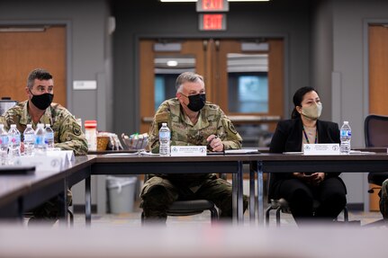 Gen. Glen VanHerck, Commander, North American Aerospace Defense Command and U.S. Northern Command, meets with Task Force McCoy senior leaders, Fort McCoy Senior Commander and Commanding General of the 88th Readiness Division, Maj. Gen. Darrell Guthrie, Task Force McCoy Commanding General, Brig. Gen. Christopher Norrie, and Department of Homeland Security Federal Coordinator for Fort McCoy, Angie Salazar, on Sept. 26, 2021. The Department of Defense, through U.S. Northern Command, and in support of the Department of Homeland Security, is providing transportation, temporary housing, medical screening, and general support for at least 50,000 Afghan evacuees at suitable facilities, in permanent or temporary structures, as quickly as possible. This initiative provides Afghan evacuees essential support at secure locations outside Afghanistan.  (U.S. Army Photo by Spc. Froylan Grimaldo / 7th Mobile Public Affairs Detachment.)
