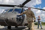 Michigan Army National Guard’s Sgt. 1st Class John Sheehan, the state standardization instructor for Joint Forces Headquarters in Lansing, talks with first responders in Ionia, Michigan, about items carried in the Black Hawk helicopter Sept. 15, 2021. The Army Aviation Support Facility conducted cold-load and aircraft familiarity training with civilian partners during a pre-accident plan rehearsal.