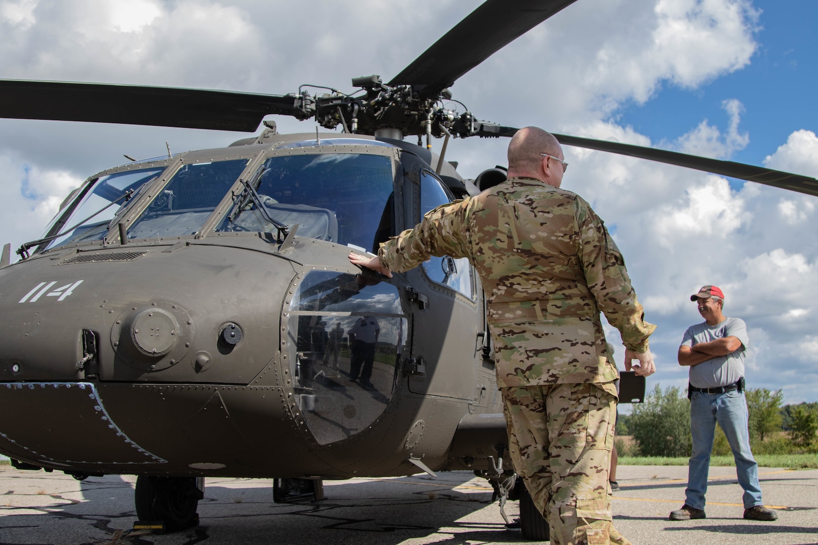 Michigan Army National Guard’s Sgt. 1st Class John Sheehan, the state standardization instructor for Joint Forces Headquarters in Lansing, talks with first responders in Ionia, Michigan, about items carried in the Black Hawk helicopter Sept. 15, 2021. The Army Aviation Support Facility conducted cold-load and aircraft familiarity training with civilian partners during a pre-accident plan rehearsal.