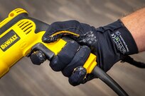 A pipefitter with Shop 56, Pipefitters, learns how the "Ironhand" can augment a shipyard worker's grip Aug. 25, 2021, during Puget Sound Naval Shipyard & Intermediate Maintenance Facility's 2021 Technology Showcase at the Kitsap Conference Center in Bremerton, Washington. (PSNS & IMF photo by Scott Hansen)