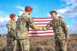 Staff Sgt. David Cobb, right, assigned to the 143rd Infantry Regiment (Airborne), reenlists at the Houtdorpveld drop zone during Falcon Leap, NATO's largest Airborne technical exercise, in the Netherlands Sept. 16, 2021.