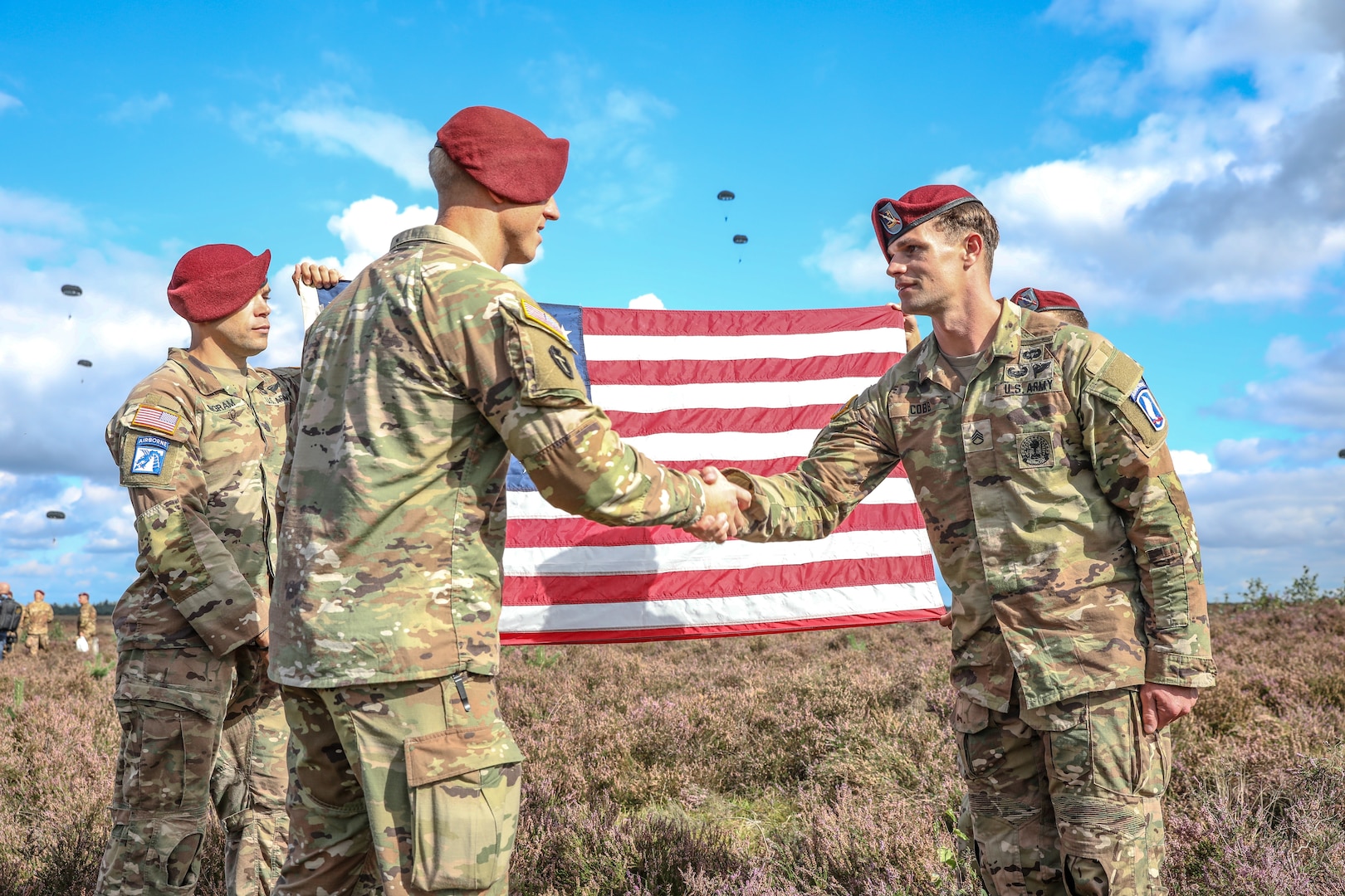 Staff Sgt. David Cobb, right, assigned to the 143rd Infantry Regiment (Airborne), reenlists at the Houtdorpveld drop zone during Falcon Leap, NATO's largest Airborne technical exercise, in the Netherlands Sept. 16, 2021.