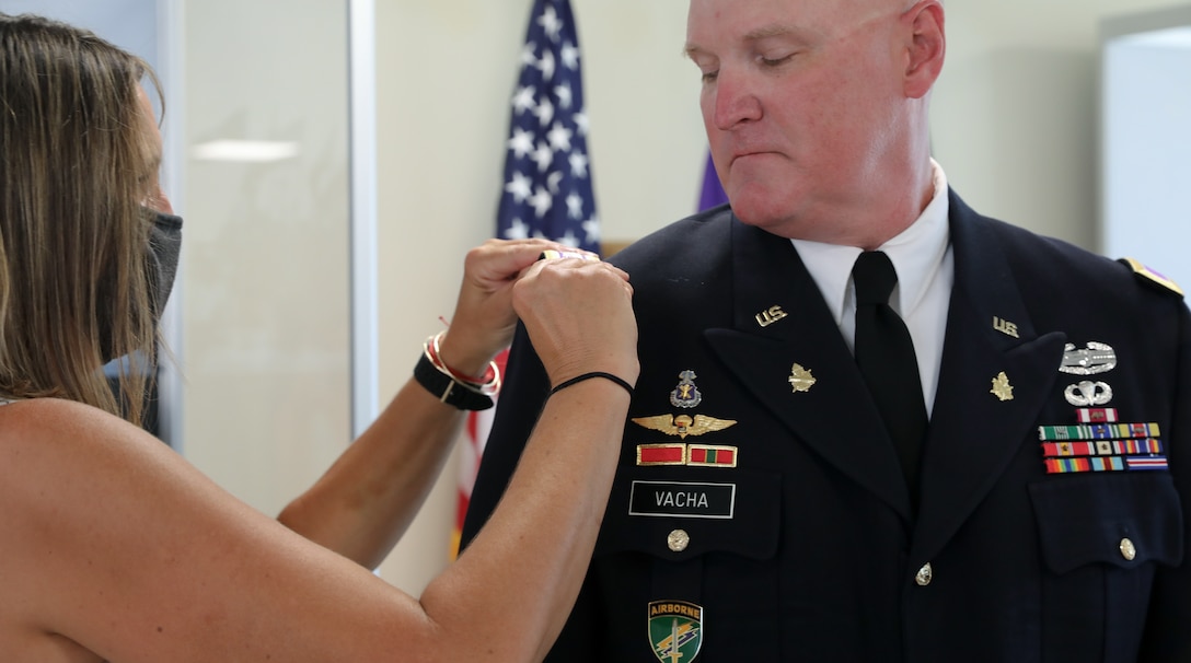 Mrs. Lara Vacha pins the rank of colonel on her husband, U.S. Army Reserve Col. Donald A. (Tony) Vacha, incoming deputy commanding officer for the 353 Civil Affairs Command, during his promotion ceremony held at the John F. Kennedy Special Warfare Center and School, Aug. 27, 2021, Fort Bragg, N.C.