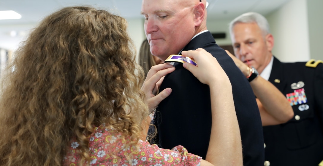 Ms. Emma Vacha pins the rank of colonel on her father, U.S. Army Reserve Col. Donald A. (Tony) Vacha, incoming deputy commanding officer for the 353 Civil Affairs Command, during his promotion ceremony held at the John F. Kennedy Special Warfare Center and School, Aug. 27, 2021, Fort Bragg, N.C.