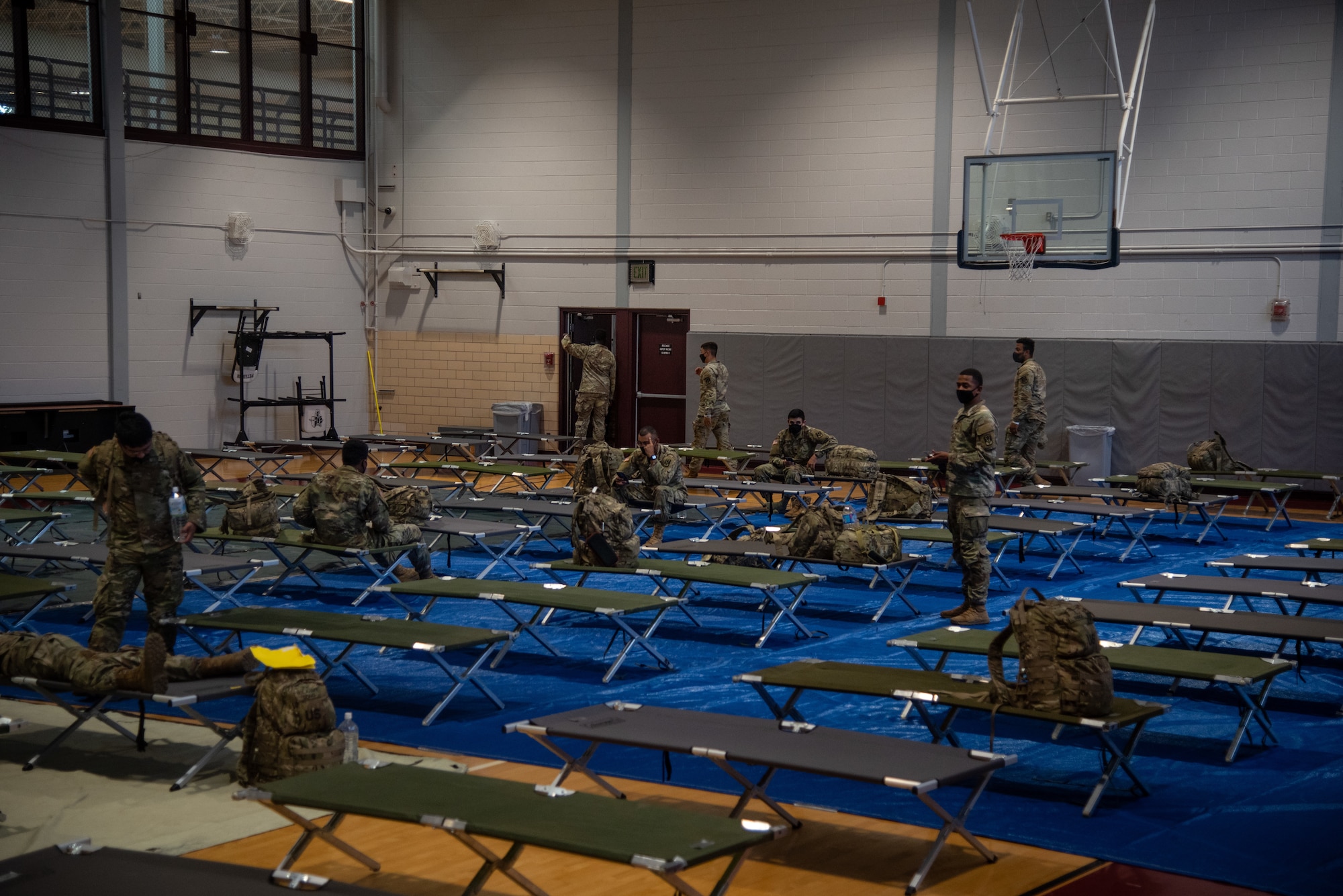 soldiers sitting on cots