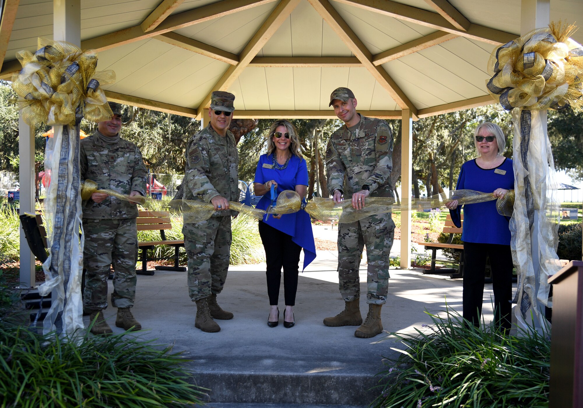 Keesler personnel participate in a ribbon cutting ceremony during the Air Force Families Forever Fallen Heroes Butterfly Garden dedication ceremony at the marina park at Keesler Air Force Base, Mississippi, Sept. 24, 2021. The garden was created as a designated location where the families of our fallen heroes can find a serene area to pay tribute to their loved one as well as honoring our fallen service members. (U.S. Air Force photo by Kemberly Groue)