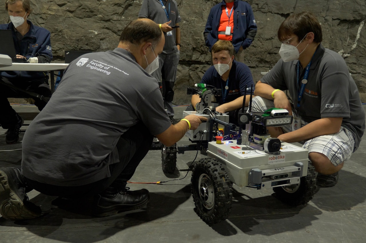 People gather around a robot.