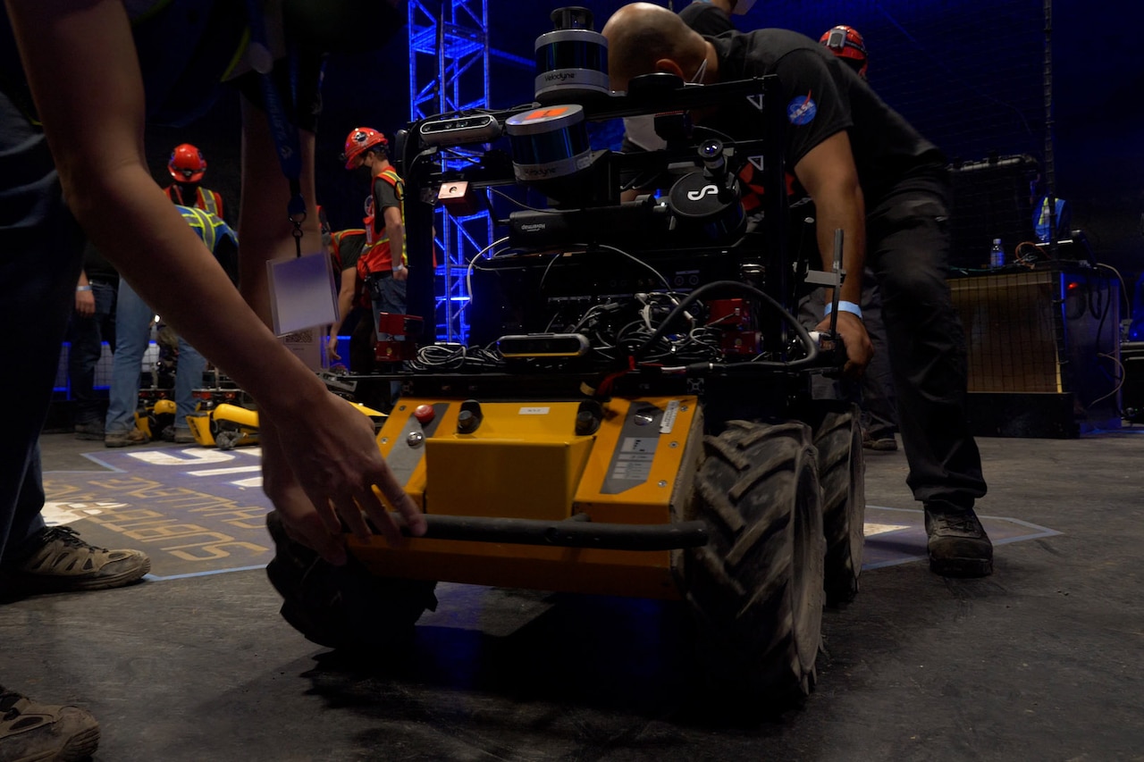 People gather around a robot.