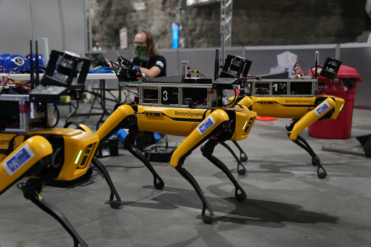 People gather around robots.