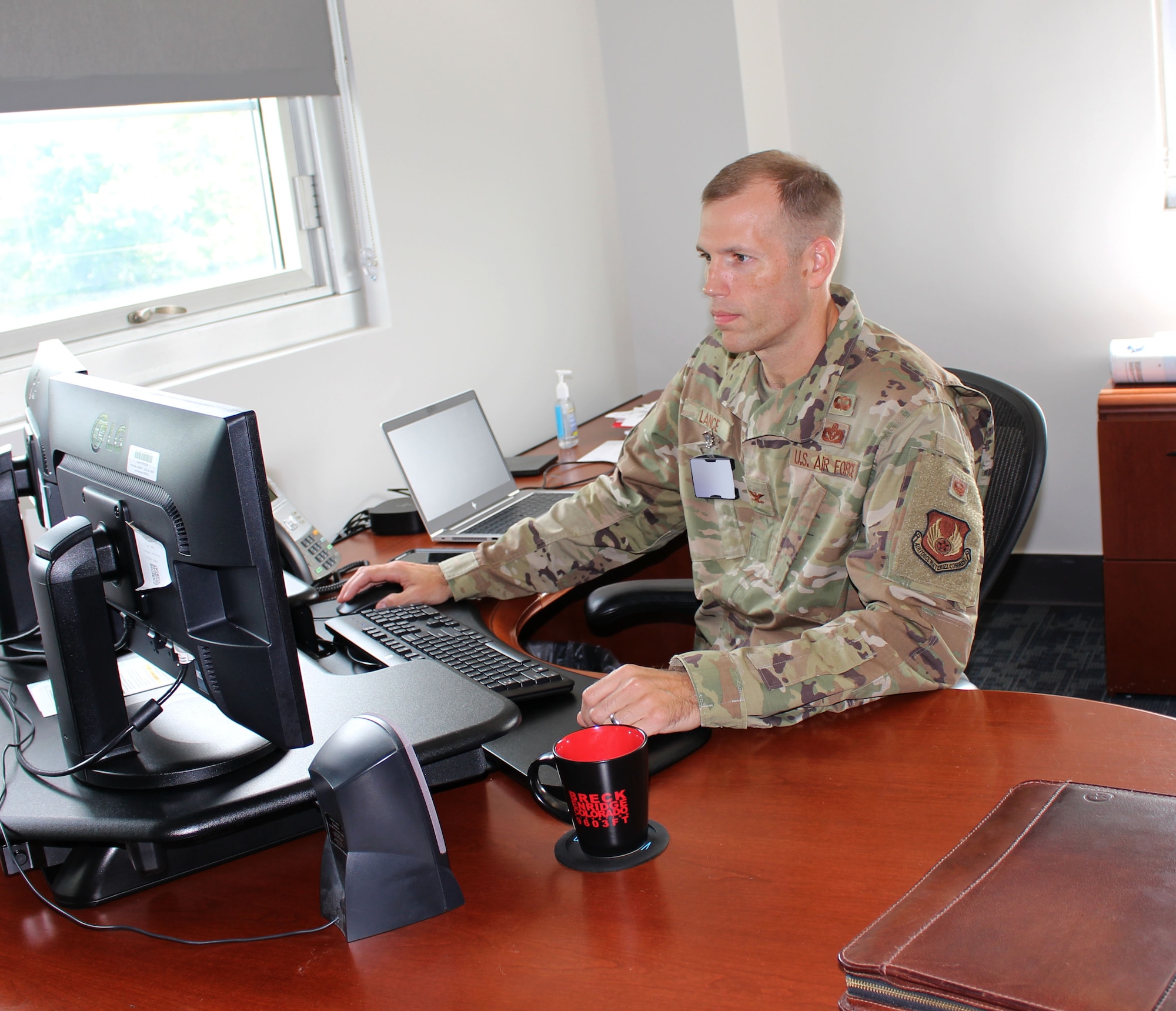 Col. Robert Lance, chief of the Arnold Engineering Development Complex Test Support Division, works in his office at Arnold Air Force Base, Tenn., Aug. 20, 2021. (U.S. Air Force photo by Deidre Moon) (This image has been altered by blurring a badge for security purposes.)