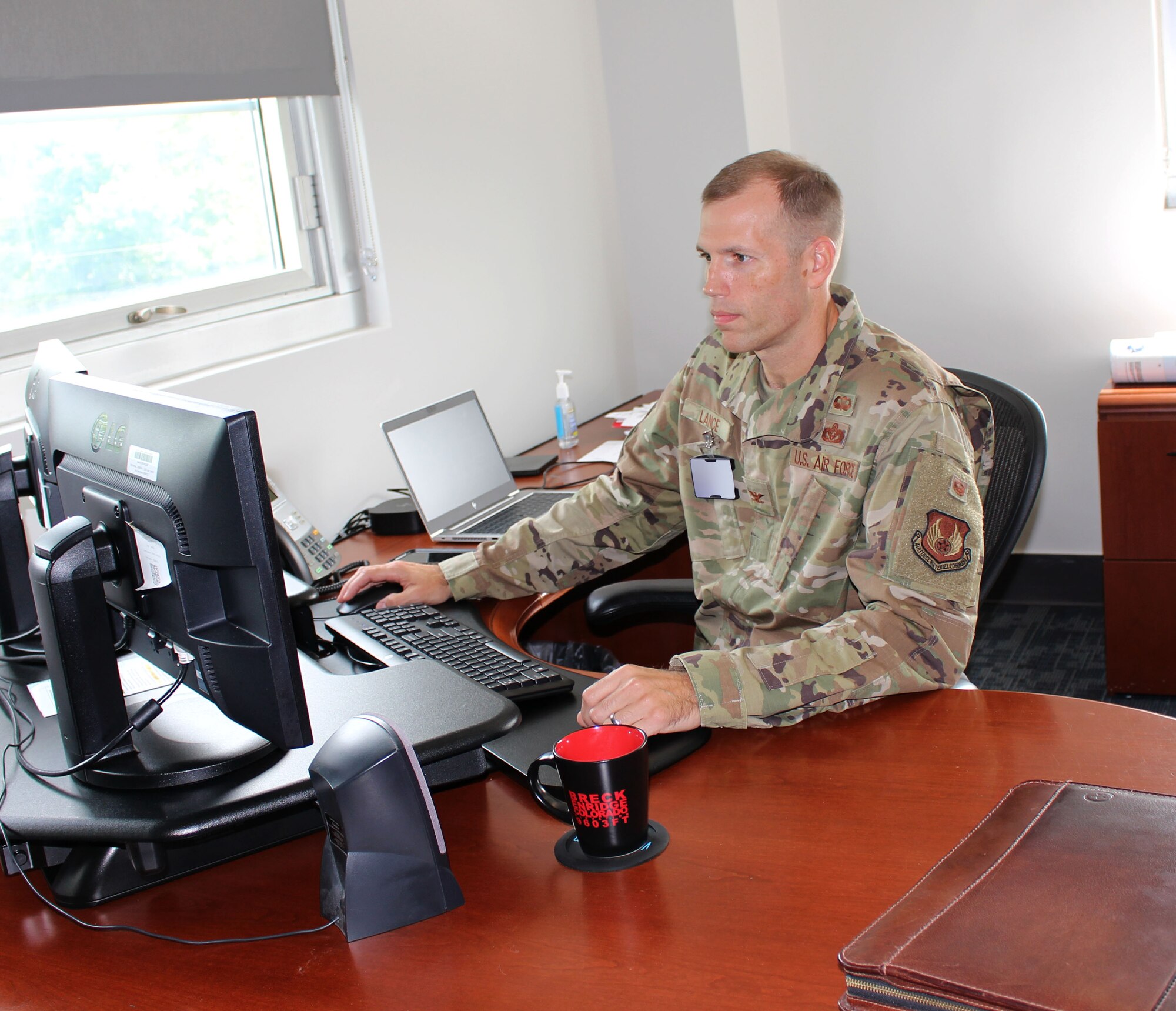 Col. Robert Lance, chief of the Arnold Engineering Development Complex Test Support Division, works in his office at Arnold Air Force Base, Tenn., Aug. 20, 2021. (U.S. Air Force photo by Deidre Moon) (This image has been altered by blurring a badge for security purposes.)
