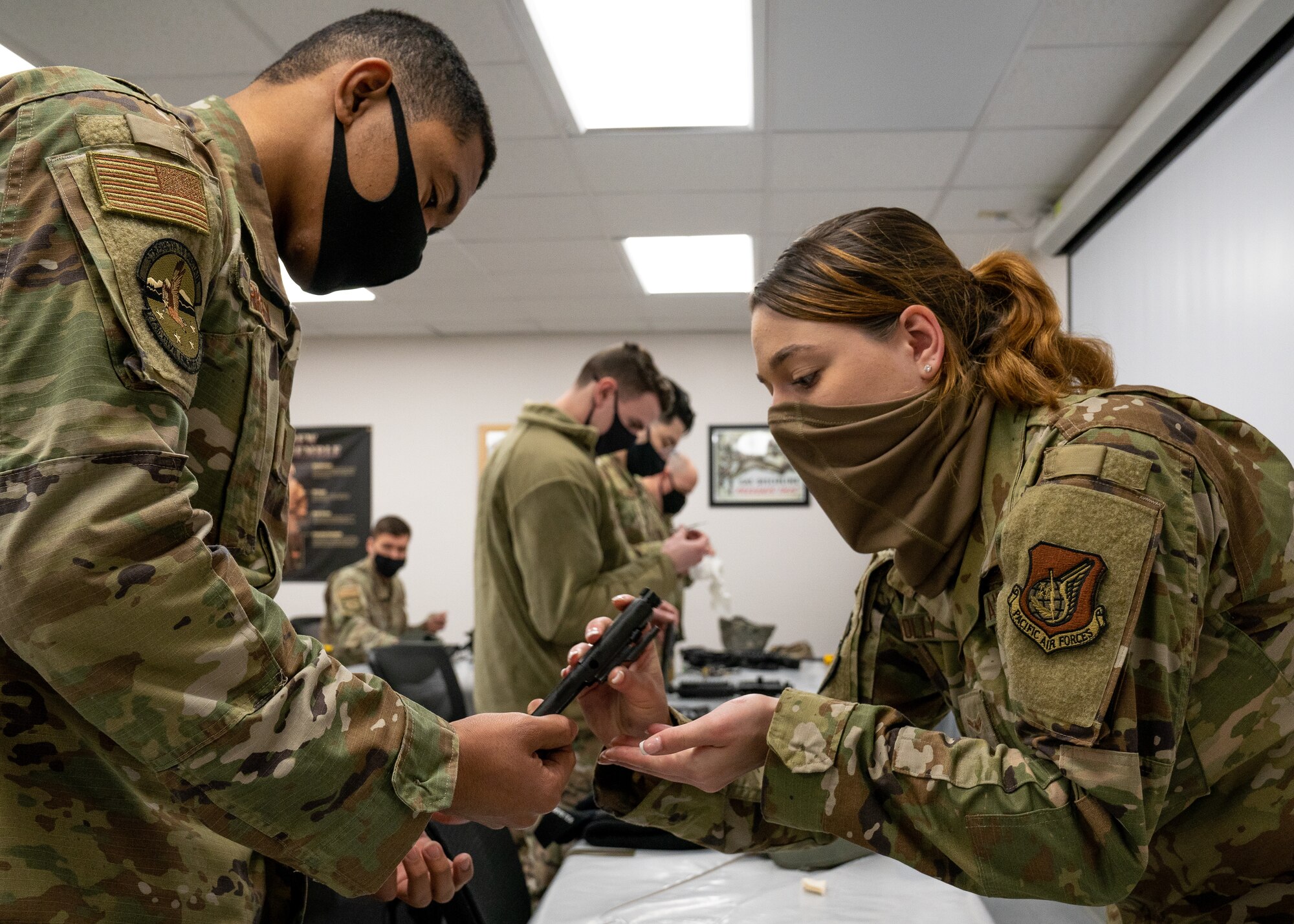 Airmen assigned to the 773d Civil Engineer Squadron practice assembly and cleaning of M4 carbines during Prime Base Engineer Emergency Force Day.