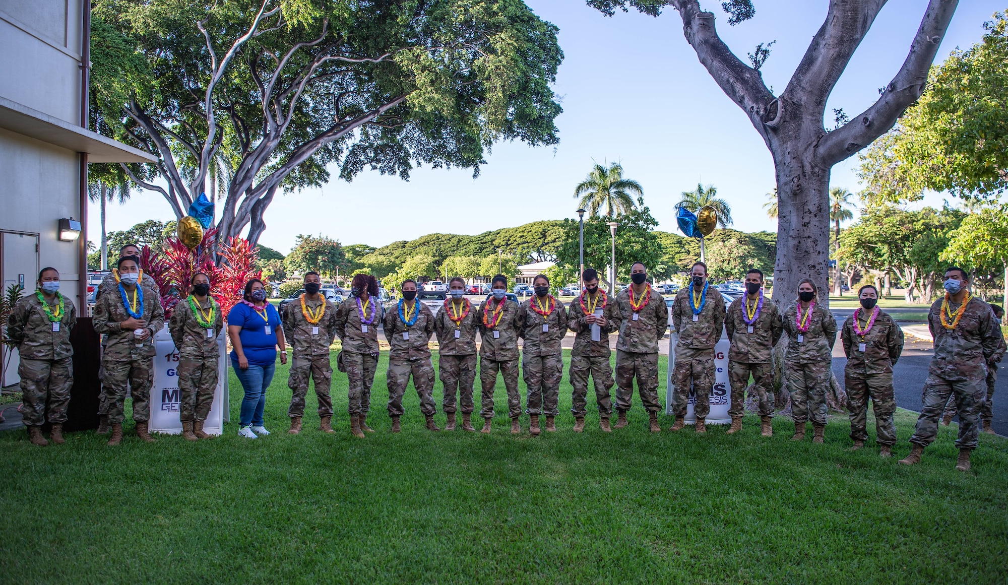 Super User volunteers from the 15th Medical Group stand together after receiving leis during the Military Health System Genesis launch ceremony at Joint Base Pearl Harbor-Hickam, Hawaii, Sept. 25, 2021. Super Users go through additional in-depth training and act as the first-line of support during the initial launch of MHS Genesis. (U.S. Air Force photo by Senior Airman Alan Ricker)