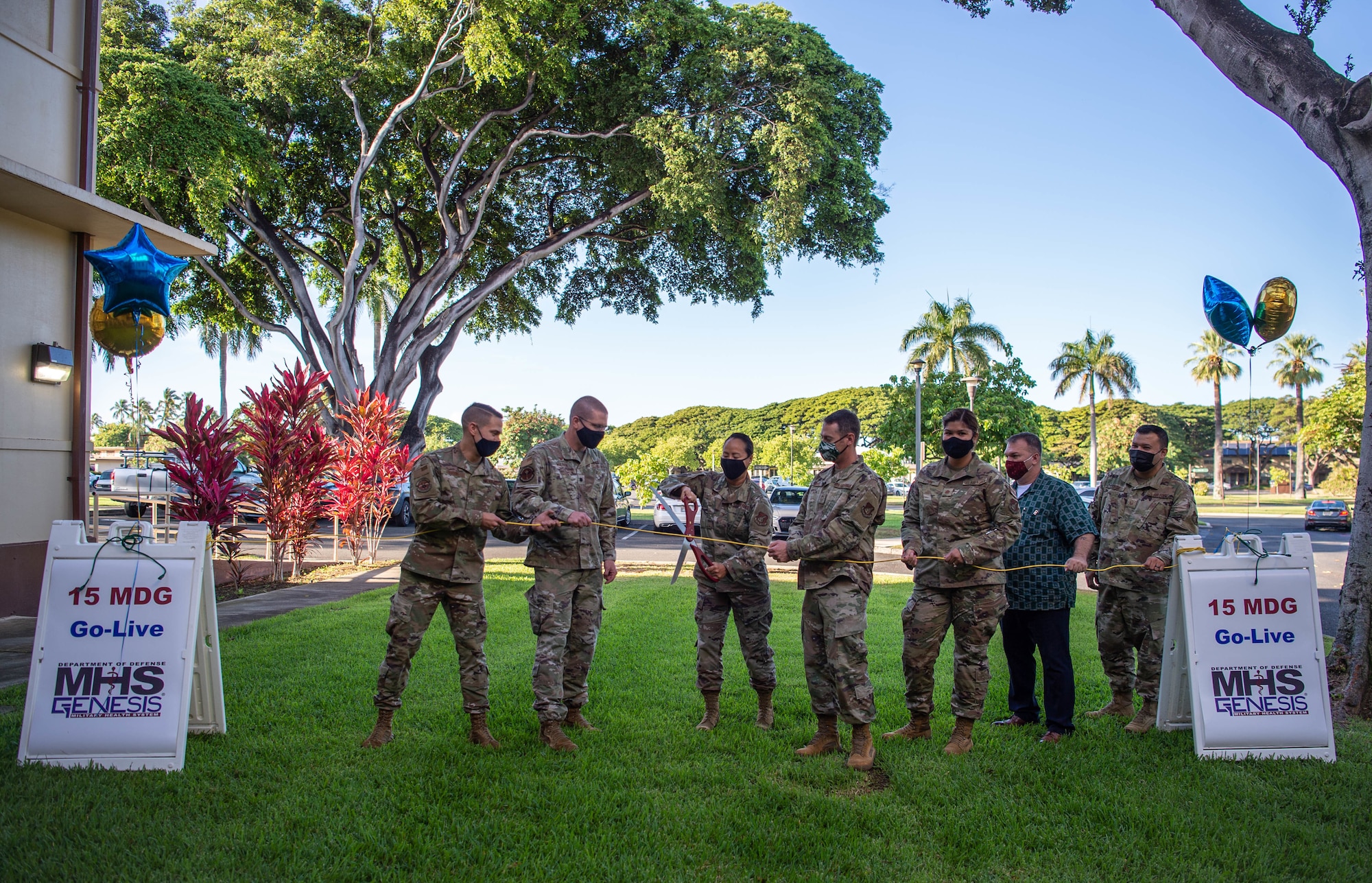 Col. Stephanie Ku, 15th Medical Group commander, cuts a cord with 15th MDG members and Military Health System Genesis project integrators during the MHS Genesis launch ceremony at Joint Base Pearl Harbor-Hickam, Hawaii, Sept. 25, 2021. More than 9.5 million Department of Defense beneficiaries are able to access their electronic health care records through the new electronic health record system. (U.S. Air Force photo by Senior Airman Alan Ricker)
