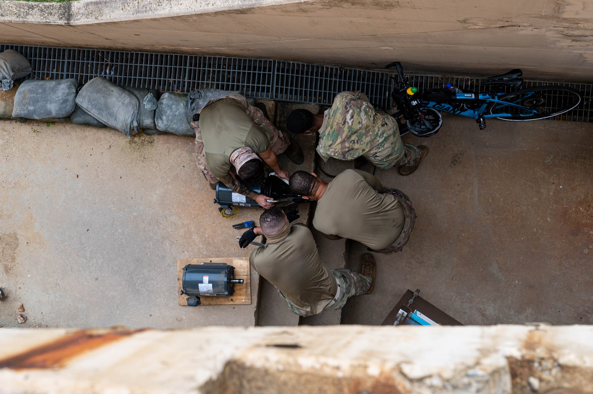 51st Civil Engineering Squadron heating ventilation and air conditioning (HVAC) technicians, work on a motor and pulley for an air handling unit