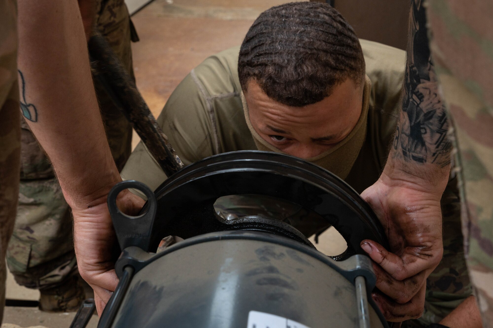 Senior Airman James Stone, 51st Civil Engineering Squadron heating ventilation and air conditioning (HVAC) technician, checks the alignment of a pulley