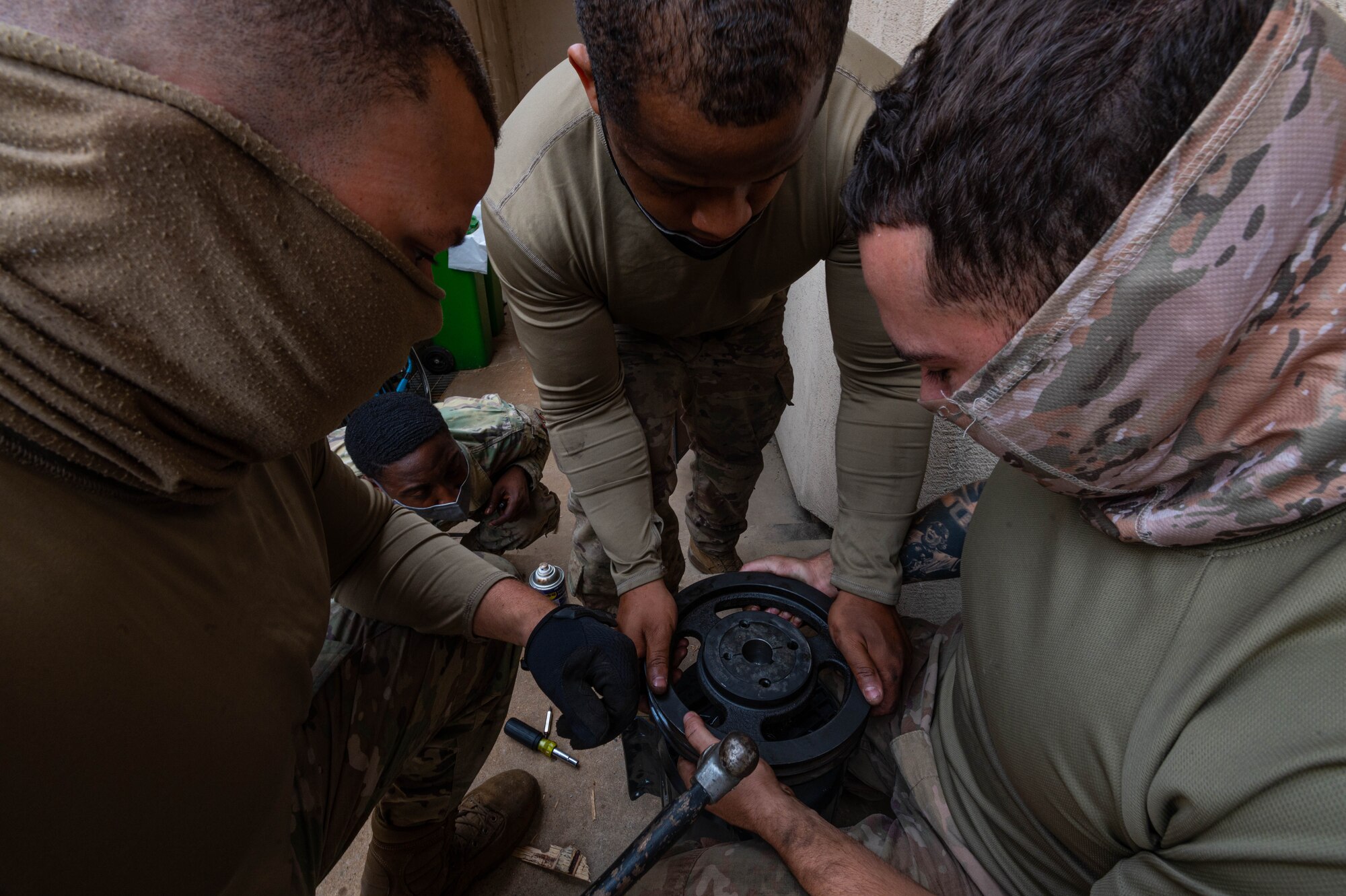 51st Civil Engineering Squadron heating ventilation and air conditioning (HVAC) technicians, take a usable pulley off of a defective motor and attach it to a working air handling unit motor