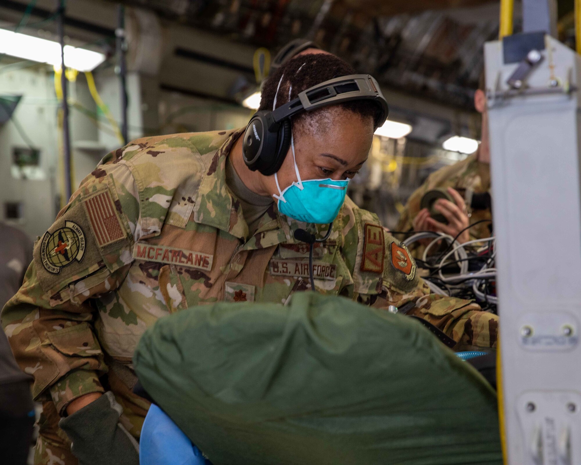 Airman prepares equipment during aeromedical evacuation.