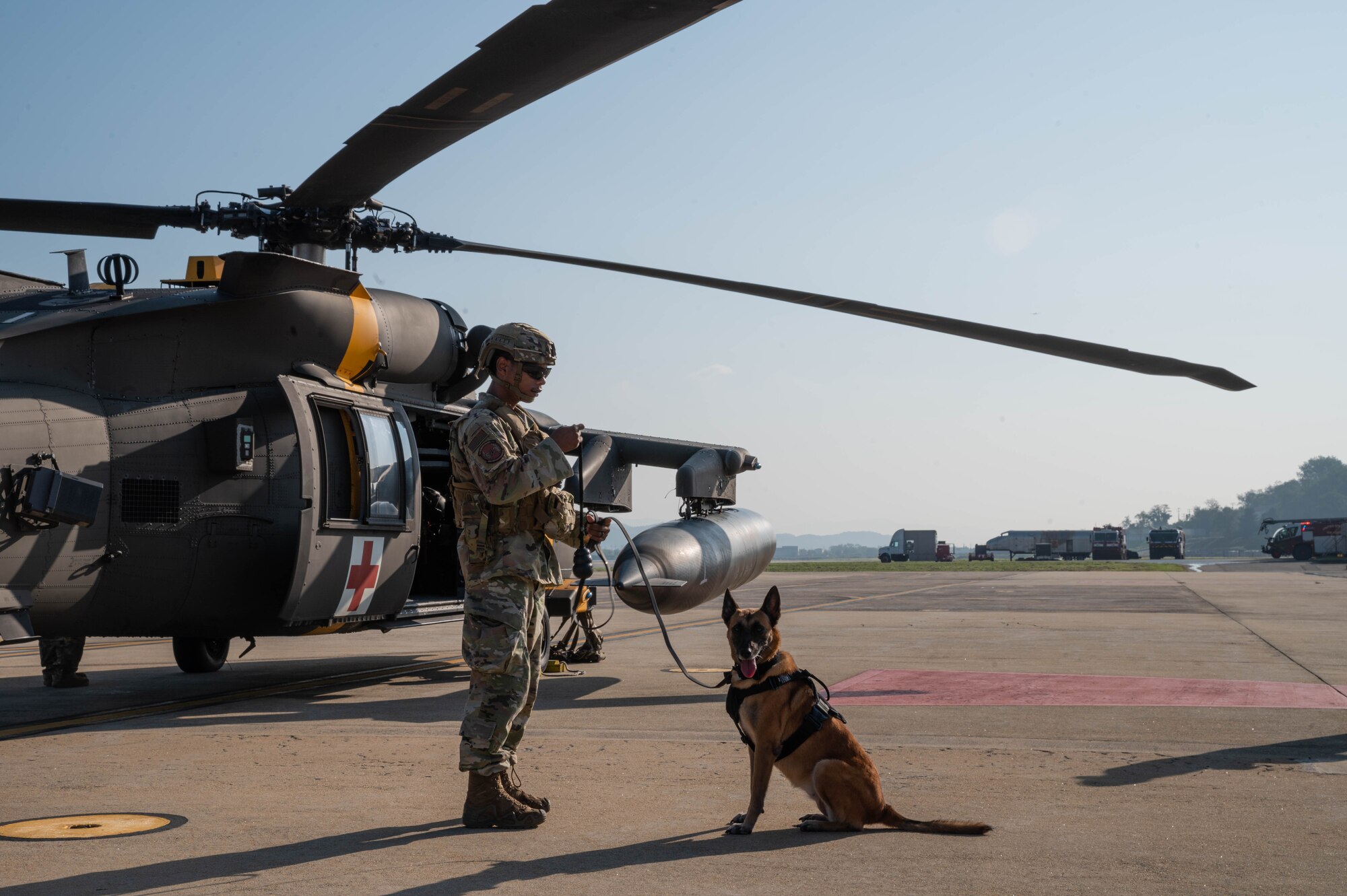 Staff Sgt. Kyle Ashton Young, 51st Security Forces squadron, military working dog handler, prepares MWD Afrika to board a U.S. Army HH-60 Black hawk