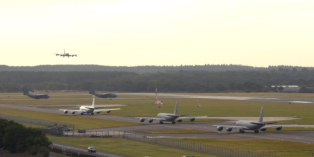Team Mildenhall aircraft pause for a plane to land as they participate in an “elephant walk” at Royal Air Force Mildenhall Sept. 13, 2021. An elephant walk is a term used by the U.S. Air Force when multiple aircraft taxi together before takeoff. (U.S. Air Force photo by Karen Abeyasekere)