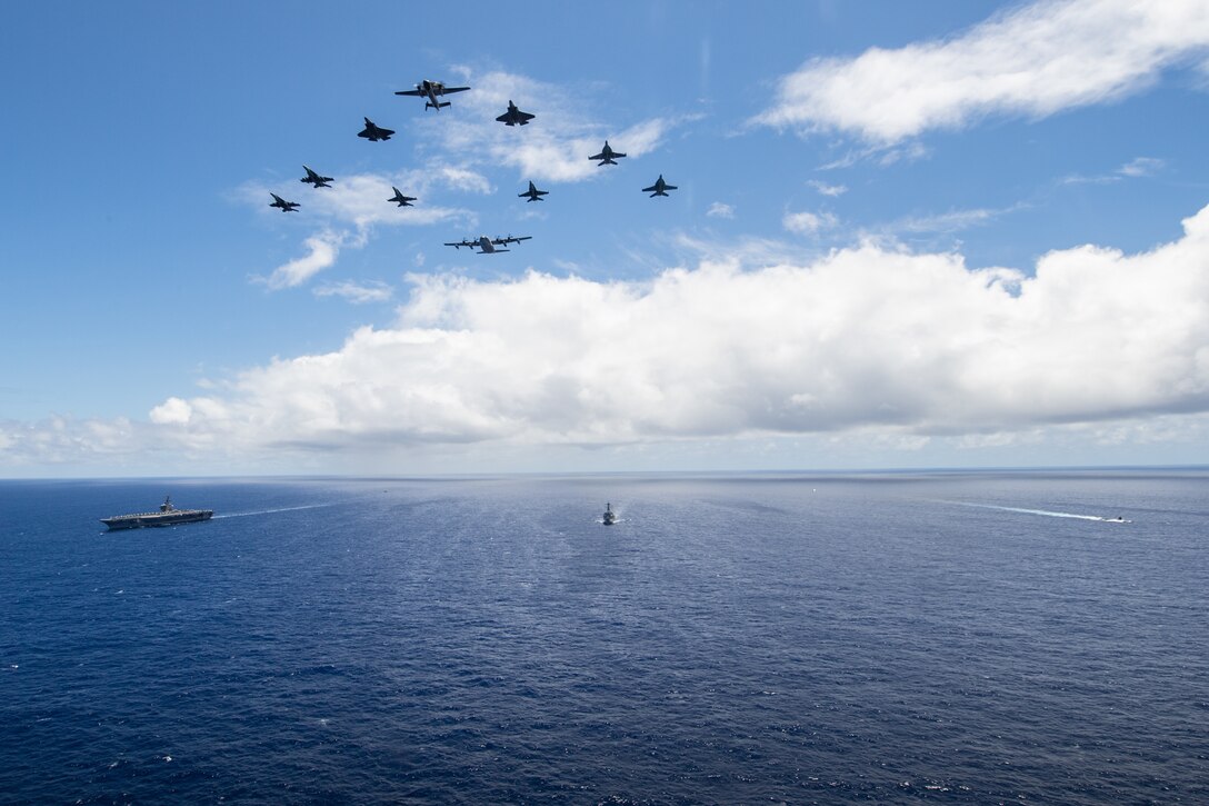 The aircraft carrier USS Carl Vinson (CVN 70), guided-missile destroyer USS Dewey (DDG 105), and attack submarine USS Seawolf (SSN 21) sail in formation while aircraft from Marine Fighter Attack Squadron (VMFA) 323 and Marine Aerial Refueler Transport Squadron (VMGR) 352 fly over the formation in the Hawaiian Islands Operating Area, June 22.