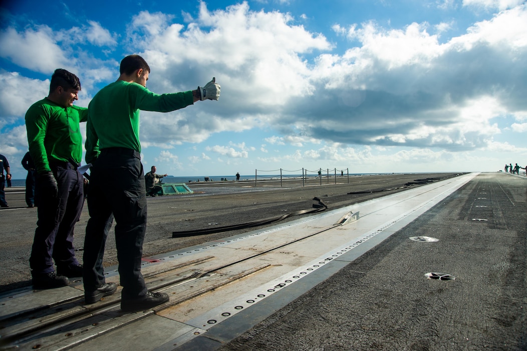 Sailors signal a catapult launch during a no-load catapult test on the flight deck of the Nimitz-class aircraft carrier USS Harry S. Truman (CVN 75).