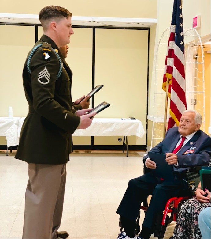 group of people standing with a man in a wheelchair.