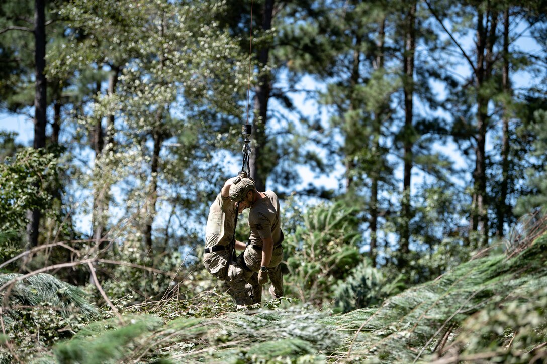 Photo of two Airmen in the woods