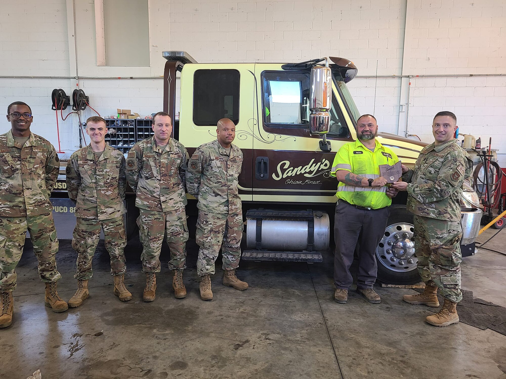 Lt. Col. Brian Eichers, 445th Logistics Readiness Squadron commander, presents a plaque to Sandy’s Towing and Recovery during the September unit training assembly for their support of the squadron. Sandy’s Towing and Recovery established a program with LRS back in 2019 to provide hands-on training to LRS Airmen. To date, the company has provided training for 12 operators, conducted 20 hours of training, executed 12 core tasks directly related to their Career Field Education and Training Plan and accomplished upgrade training.

The Airmen have learned about the different types of wreckers and recovery vehicles, operational safety, recovery equipment, caging and uncaging air brakes, techniques and use of a tow bar and wheel lift. They’ve also been shown overturned vehicles, recovery of disabled vehicles, loading onto a flatbed truck, straight towing and wheel removal (single and dual).