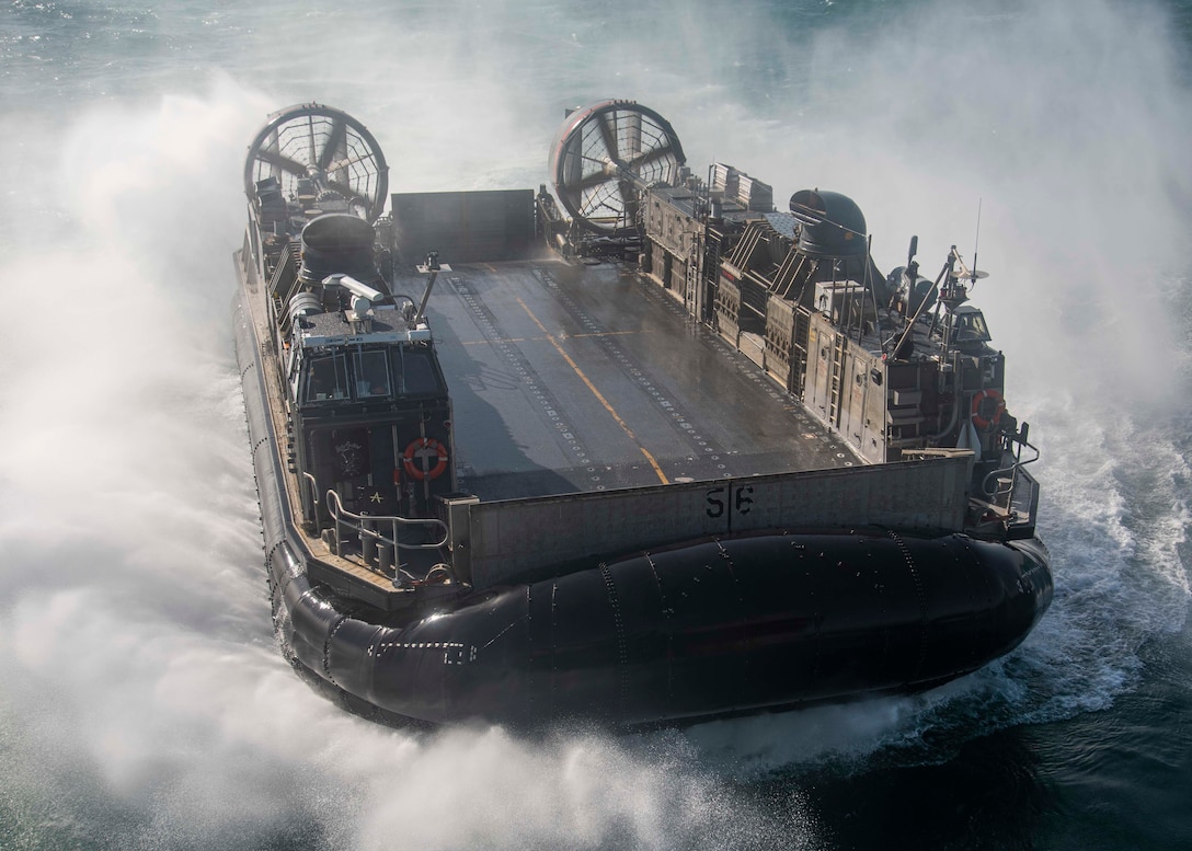 ARABIAN GULF (Sept. 26, 2021) Landing craft, air cushion attached to Assault Craft Unit Five (ACU 5) prepares to enter the well deck of the amphibious assault ship USS Essex (LHD 2), Sept. 26. ACU 5 is deployed with Essex and the 11th Marine Expeditionary Unit to the U.S. 5th Fleet area of operations in support of naval operations to ensure maritime stability and security in the Central Region, connecting the Mediterranean and the Pacific through the western Indian Ocean and three strategic choke points. (U.S. Navy photo by Mass Communication Specialist 2nd Class Jenna Dobson)