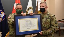 Lt. Gen. Daniel L. Karbler, left, commanding general of the U.S. Army Space and Missile Defense Command passes the command chief warrant officer charter to Chief Warrant Officer 5 Anson L. Seebeck, incoming SMDC CCWO during a Change of Charter, Sept. 27, at the command’s Redstone Arsenal headquarters. Seebeck assumes responsibility from SMDC’s first CCWO Chief Warrant Officer 5 Wesley Klees. (U.S. Army photo by Jason Cutshaw)