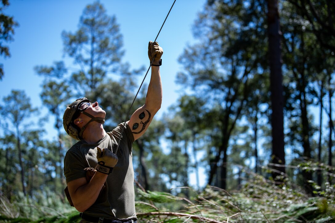 Photo of an Airman holding a rope
